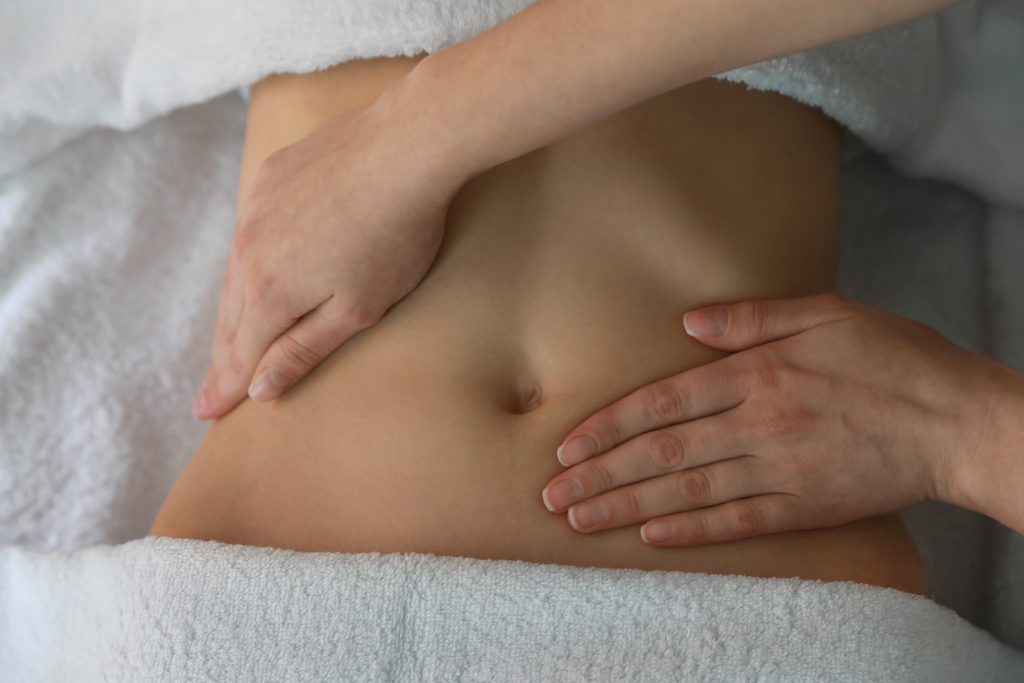 Woman receiving professional belly massage, closeup view